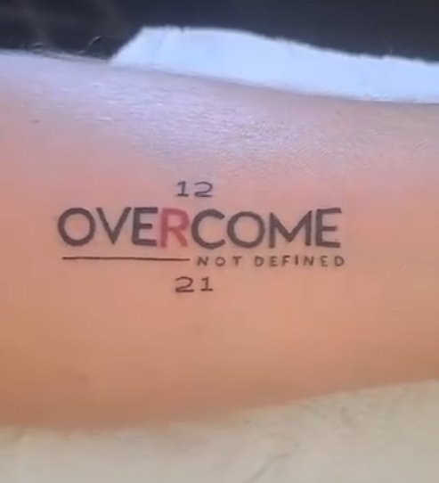 Overcome script tattoo by Skin Deep Tattoos